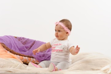 Fototapeta premium Cute and happy newborn baby playing, smiling, laughing with basket