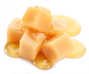 Sweet caramel candies on the white background.