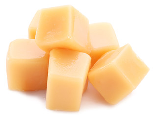 Sweet caramel candies on the white background.