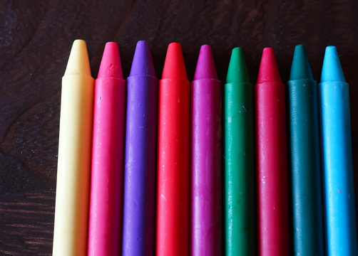 colorful Oil pastel crayons on a wooden  black table