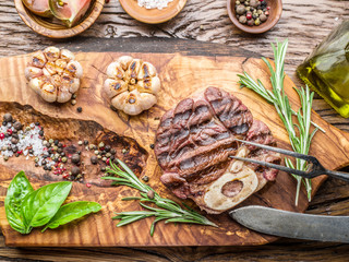 Beef steaks  with spices on a wooden tray.
