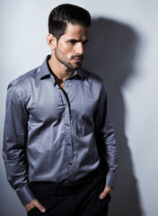 handsome young man in suit on grey background. Business man