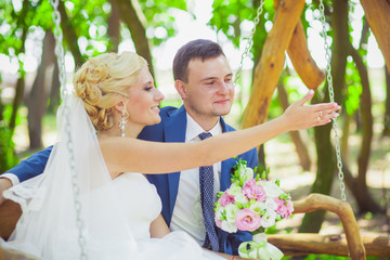 the bride and groom on a swing
