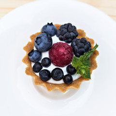 Tart  with Fresh berries - dessert on wooden table close up