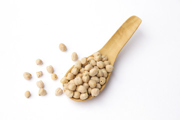 Chick peas on wooden spoon isolated on white background