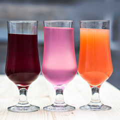 Fresh colorful lemonade (pink, purple, orange)  in glasses