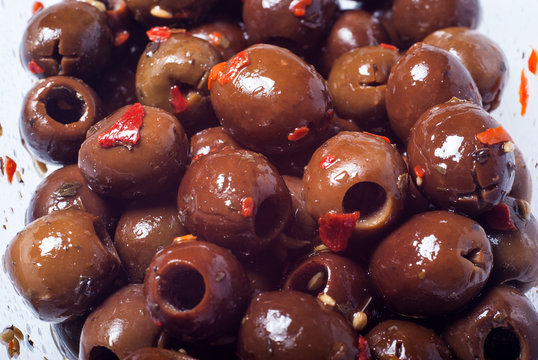 Marinated brown olives. closeup