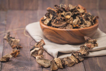 Dried mushrooms in wooden bowl