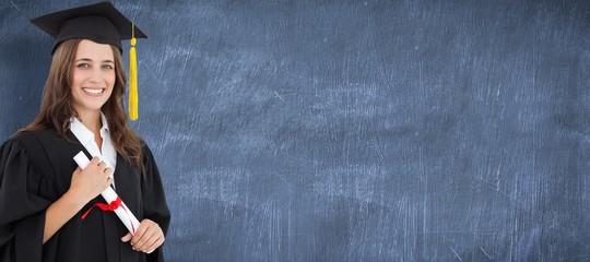 Composite image of a smiling woman with a degree in hand