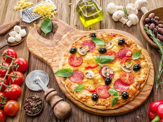 Pizza with mushrooms, salami and tomatoes.
