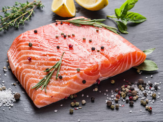 Fresh salmon on the black cutting board.