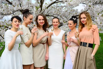 Girls with champagne celebrating in sakura's garden.