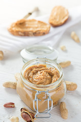 Peanut butter on wooden background.