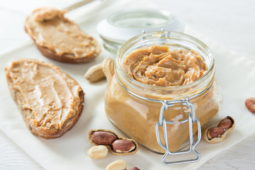Peanut butter on wooden background.