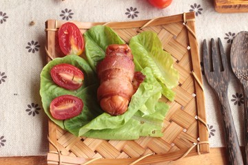 Grilled sausages wrapped in bacon fat of delicious.