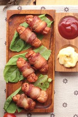 Grilled sausages wrapped in bacon fat of delicious.