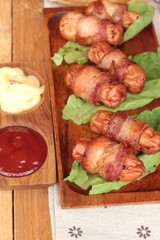 Grilled sausages wrapped in bacon fat of delicious.