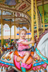 Fototapeta na wymiar Baby girl in a carousel