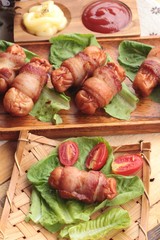 Grilled sausages wrapped in bacon fat of delicious.