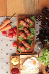 Grilled sausages wrapped in bacon fat of delicious.