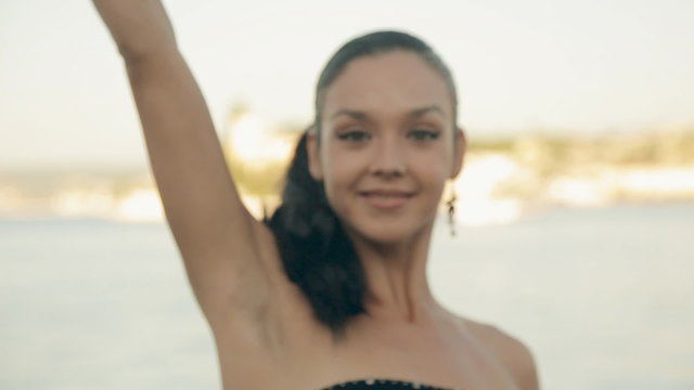 Seductive brunette wearing in a black strapless dress posing
