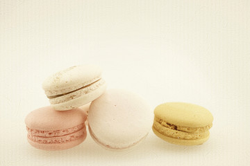 macaroons in vintage color style on mulberry paper texture

