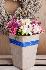 Bouquet of carnations and freesia flowers in a box