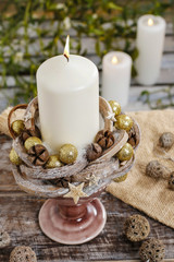Christmas decoration with candle and cones