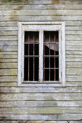 Broken window in an abandoned house