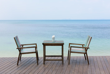 Wooden vintage table set with blue sky and sea background