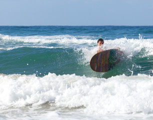 Surfer on longboard while it is falling in the waves