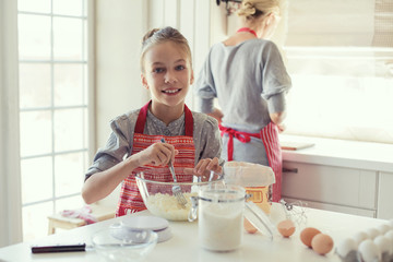 Mother and daughter are cooking