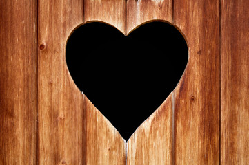 Fototapeta na wymiar A heart in wooden door