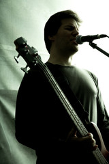 Rock singer playing bass in the rehearsal Studio