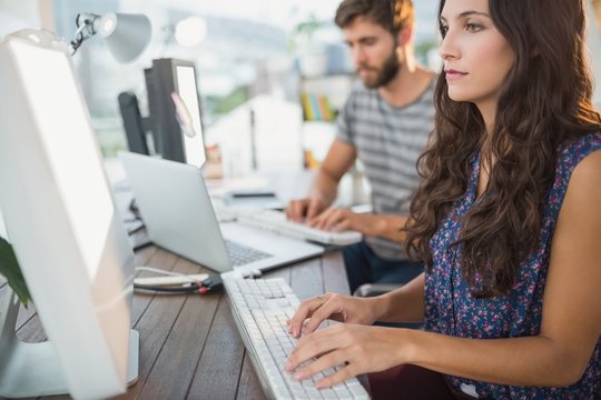  Casual business partners looking at laptop