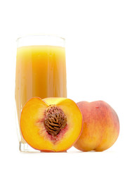 peach juice in a glass with a peach and cut sliced the peach near isolated on white background