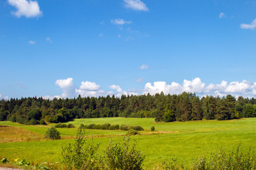 Landscape panoramic field. Panorama meadow farm fields. Nature in summer. Wheat and mown grass. Big clouds. Rustic panoramic picture. Autumn meadow.