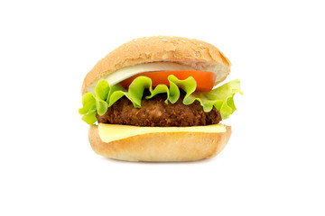 hamburger with fresh leaf lettuce cheese slice chop tomatoes and onion rings isolated on white background 
