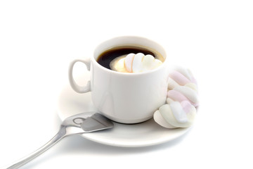 cup of coffee with marshmallows with a spoon isolated on white background
