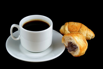 cup of coffee with a croissant  isolated on a black background
