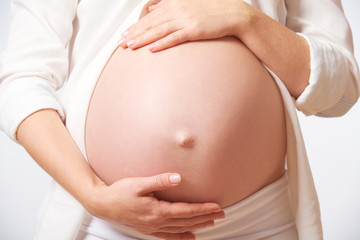 Fototapeta na wymiar belly tummy of pregnant woman on white background