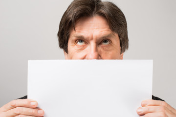 man holding a blank sheet of paper