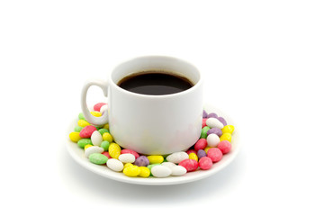 cup of coffee on a saucer with sweets isolated on white background