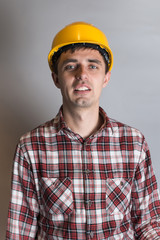 young man in a construction helmet, builder