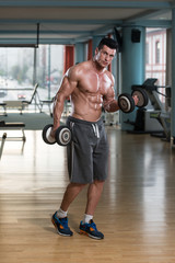 Fototapeta na wymiar Young Man Doing Exercise For Biceps