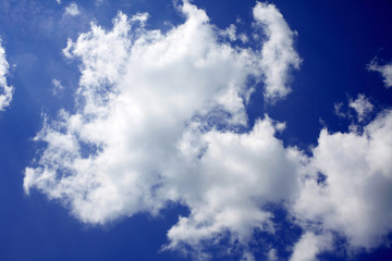 Blue sky background with a tiny clouds