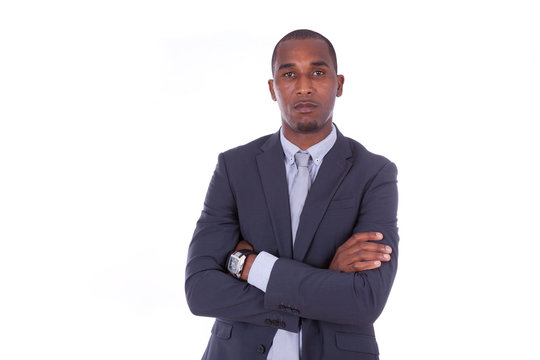 Unhappy African american business man with folded arms over whit