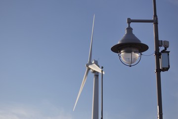 Wind mill turbine over the blue sky