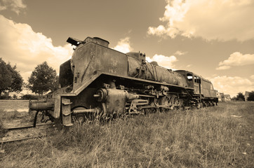 Obraz na płótnie Canvas Scenic view of a vintage style picture of an ancient abandoned locomotive.