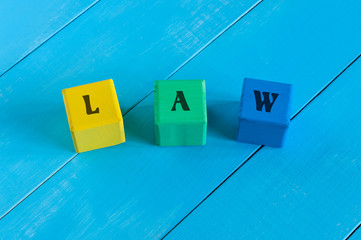 Law - word in vintage wooden colourful blocks. Business